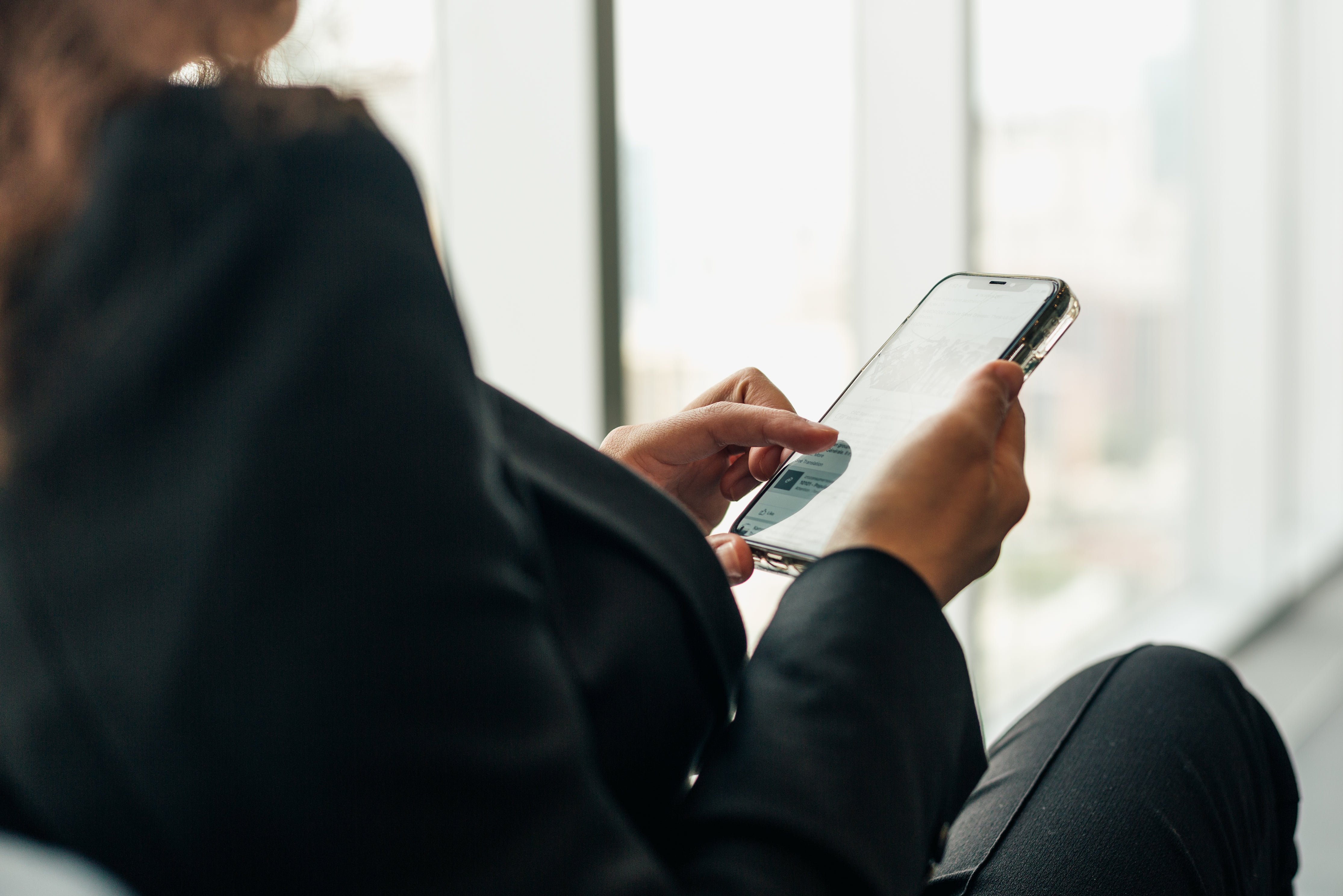 woman-holding-phone-browsing-social-media